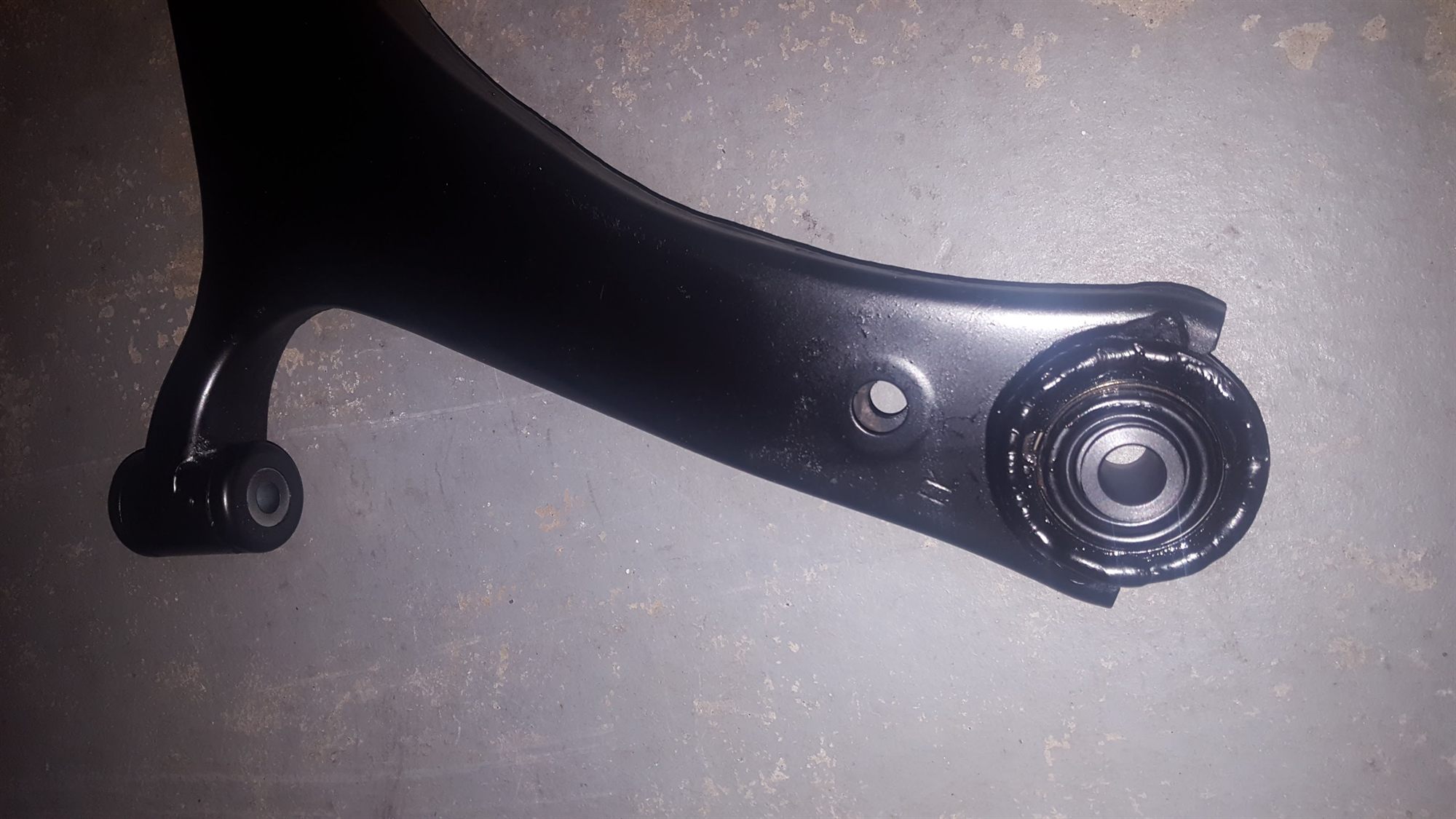 Welded control arm with the sealed spherical bearing installed